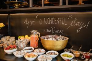 a table topped with bowls of food next to a chalkboard at Rioca Stuttgart Posto 4 in Stuttgart