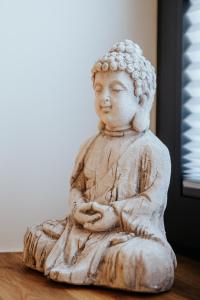 a statue of a woman sitting on a table at Village Turmzimmer in Kehl am Rhein