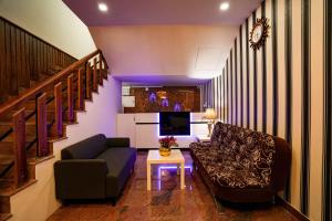 a living room with a couch and a table at Melanna Cherai Beach Resorts in Cherai Beach