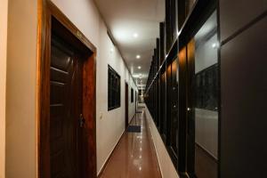 a hallway with a long corridor with wooden doors at Melanna Cherai Beach Resorts in Cherai Beach