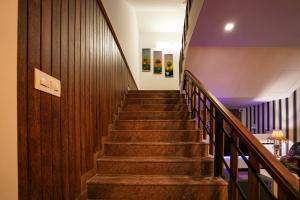 a staircase in a building with wooden walls and wooden stairs at Melanna Cherai Beach Resorts in Cherai Beach