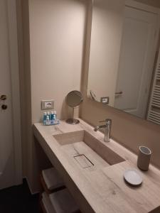 a bathroom counter with a sink and a mirror at Al Molo di Sant'Agostino in Como