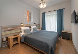 Una cama o camas en una habitación de Butikhotel Visegrád