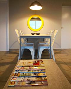 a table with chairs and a mirror on the wall at Naranjo 9D in San Salvador de Jujuy