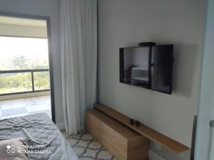 Μια τηλεόραση ή/και κέντρο ψυχαγωγίας στο Apartamento no Carpe Diem Boutique & Spa Campos do Jordão