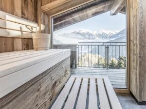 a bench in a room with a view of mountains at die Aussicht in Finkenberg