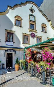 a building with flowers in front of it at Great Polonia Jelenia Góra City Center in Jelenia Góra