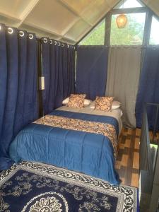 a bedroom with a bed in a tent at Chalets Resort Masinagudi in Ooty