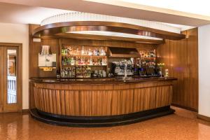 a bar in a hotel with a wooden wall at Hotel Emporda in Figueres