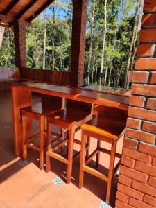 a wooden table and chairs on a patio at The Brown and Brew Homestay in Chikmagalūr