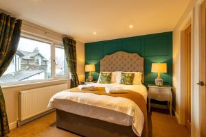 A bed or beds in a room at Holly Lodge Guest House with FREE off site health club