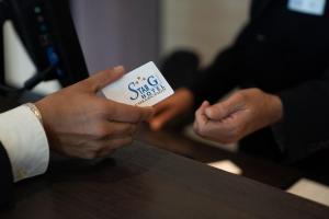 a person holding up a piece of paper with a sucker at Star G Hotel Premium München Domagkstraße in Munich