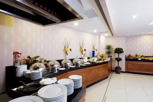 a kitchen with plates and dishes on a buffet at Tugcu Hotel Select in Bursa