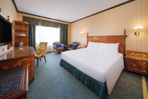 a hotel room with a large bed and a television at Hotel Lisboa in Macau