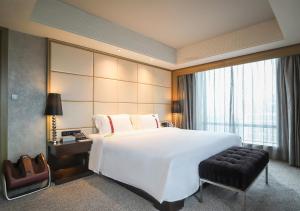 เตียงในห้องที่ Rhombus Park Aura Chengdu Hotel