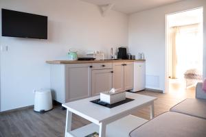 a living room with a table and a kitchen at AKORD chata in Námestovo