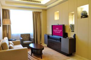 uma sala de estar com televisão de ecrã plano num quarto de hotel em Crowne Plaza Guangzhou City Centre, an IHG Hotel - Free shuttle between hotel and Exhibition Center during Canton Fair & Exhibitor registration Counter em Guangzhou