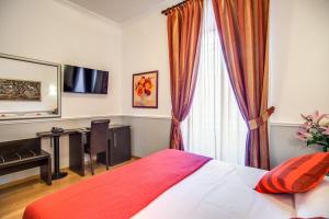 una camera con letto, scrivania e finestra di Hotel Everest Inn Rome a Roma