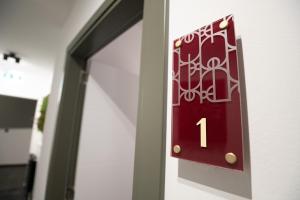 a red door with the number one on it at SAVOY residence in Osijek