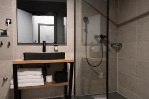 a bathroom with a sink and a shower at SAVOY residence in Osijek