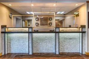 a bar in a room with glass doors at Comfort Inn Downtown - University Area in Kalamazoo