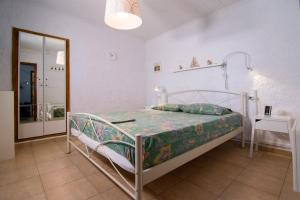 a bedroom with a bed in a room with a mirror at Summer House by the Sea in Chorefto