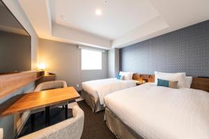 A bed or beds in a room at Tokyu Stay Sapporo Odori