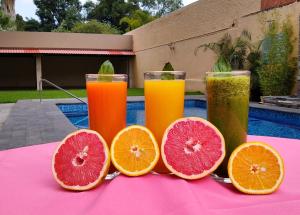 four slices of grapefruit sitting on a table with juice at Country Plaza in Guadalajara