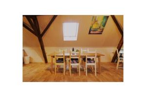 a dining room with a table and chairs at Apartmány U kapličky in Kamýk nad Vltavou