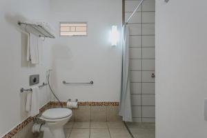 a bathroom with a toilet and a shower at Rio Quente Resorts - Hotel Giardino in Rio Quente