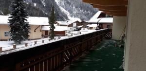 a view of a snow covered mountain from a balcony at Haus Kristall in Längenfeld