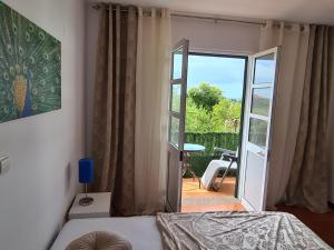 um quarto com uma cama e uma porta para um pátio em Scenic Comfort D em Ponta Delgada