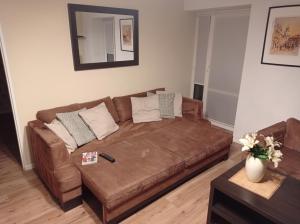 a large brown couch in a living room at Staszica Centrum in Lublin