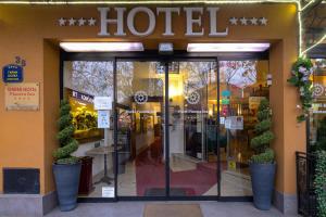 a store front of a hotel with a sign on it at Garni Hotel Planeta Inn in Novi Sad