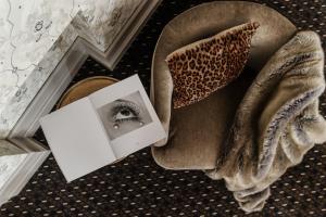 a picture of an eye and a book on the floor at Hotel H15 Francuski Old Town - Destigo Hotels in Kraków