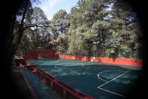 a tennis court with trees in the background at Monteverde in Mazamitla