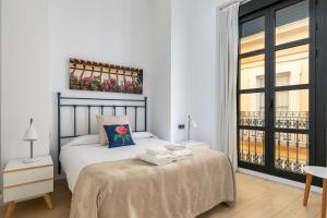 a bedroom with a bed with towels on it at Holiday Rentals Tempa Museo in Seville