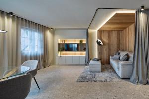 a living room with a couch and a table at Truma Swing Luxury in Merano