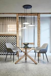 a dining room with a table and two chairs at Truma Swing Luxury in Merano