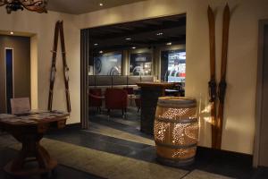 een kamer met ski's aan de muur en een tafel bij Hotel Central, Spa & lounge bar in Crans-Montana