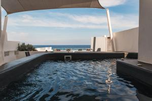 The swimming pool at or close to Almyra Oia Suites