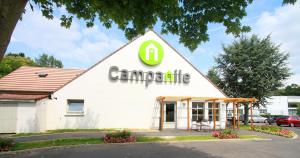 a building with a canadianknife sign on it at Campanile Hotel Chantilly in Chantilly