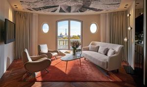 uma sala de estar com duas cadeiras e uma mesa em Hotel Lutetia em Paris