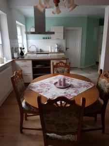 a kitchen with a table with a candle on it at Ferienwohnung am Schlosssee. in Penkun