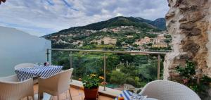 a balcony with a view of a town on a mountain at Le Perle d'Italia in Ravello