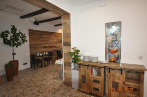 a living room with a table and a wooden door at Parkhotel Schwedt in Schwedt