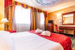 a hotel room with a bed with towels on it at Hotel Cristallo in Sestriere