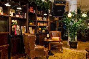 a barber shop with two chairs and a table at Browns Boutique Hotel in Lisbon