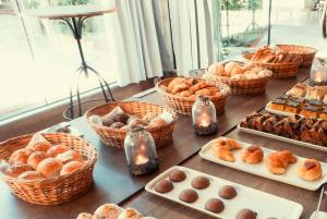 a table with many different types of pastries and bread at Pousada Aguas Claras in Búzios