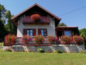 a house with flower boxes on the balcony at Holiday Home Mare near River in Karlovac